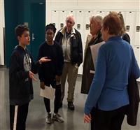 Student speaks with community partners 