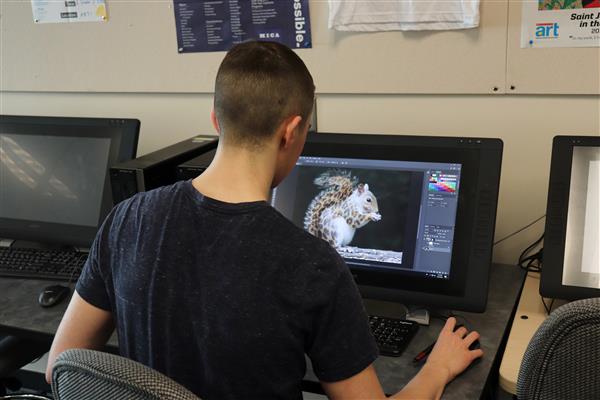 student in Journalism CTE program works on project