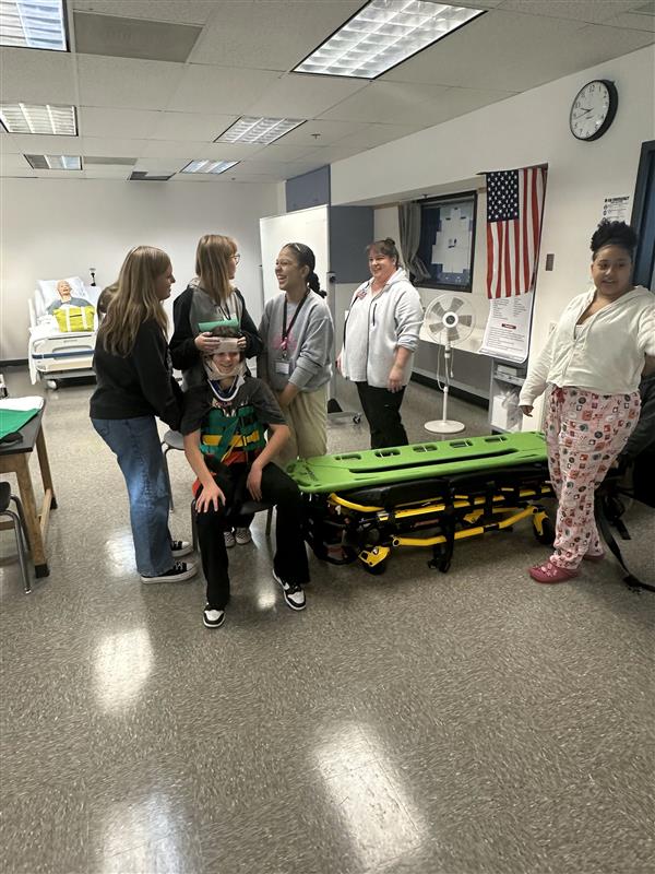 Health students move a patient